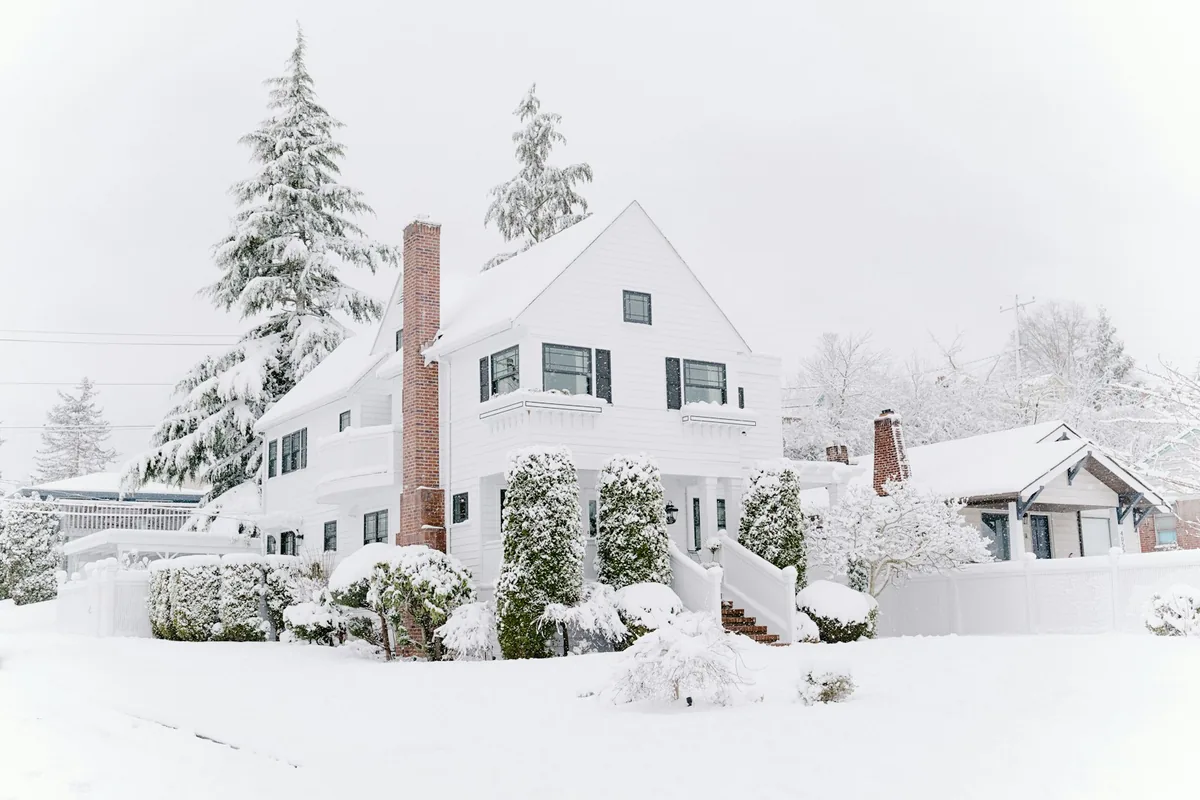 Snow-covered home and front yard in winter
